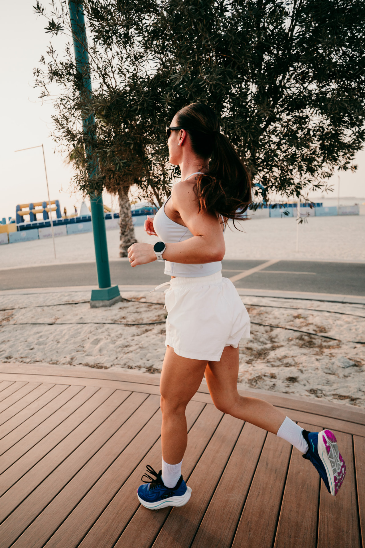 Clarice Pereira springer längs en strandpromenad